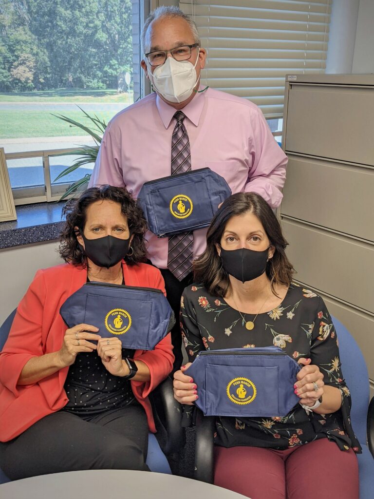 Teachers posing with PMEF cooler bags